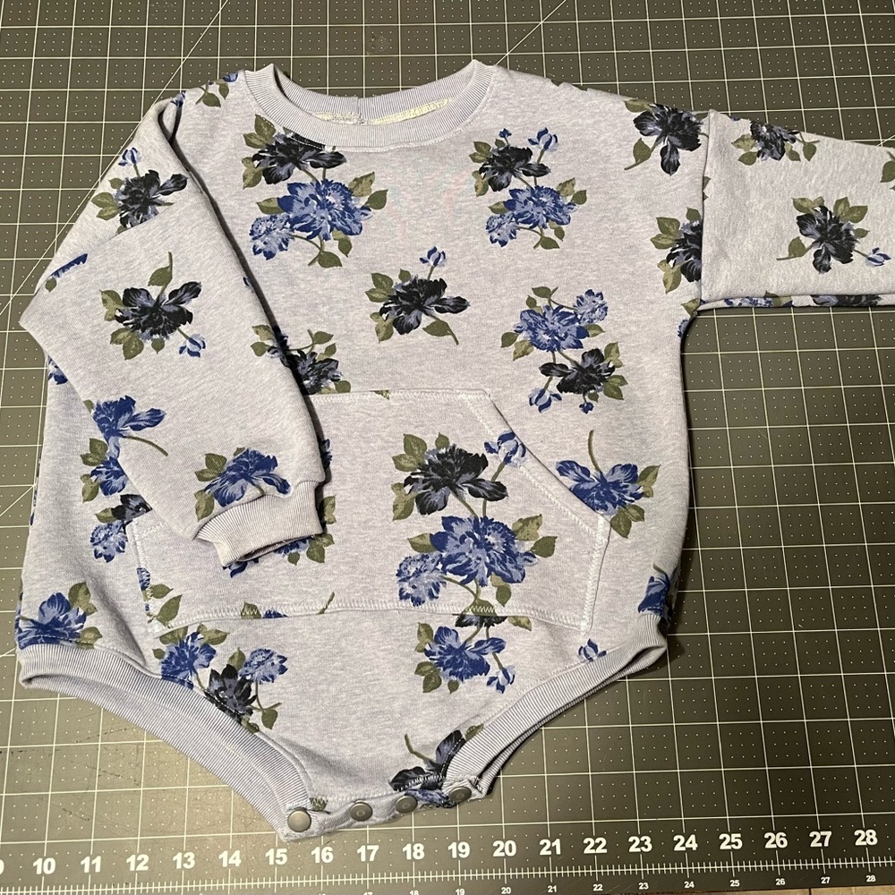 Super cute sweater romper with snaps.